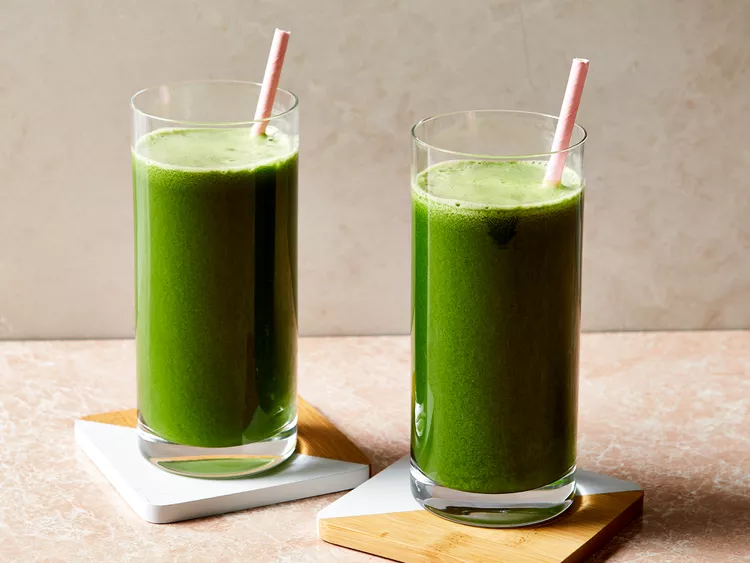 Glasses of green juice with vegetables, Fruits and veggies ready for juicing